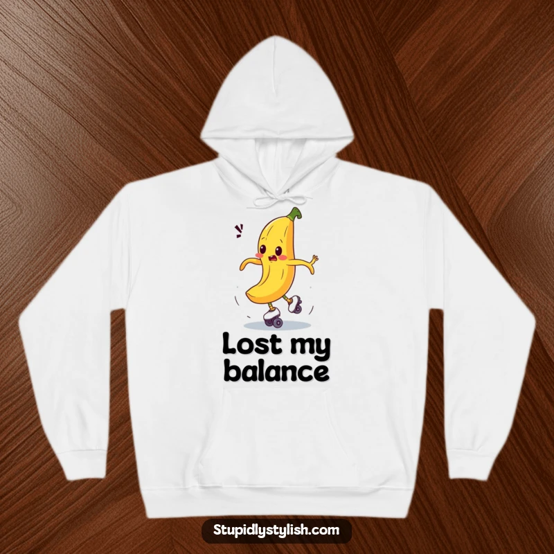 Funny hoodie depicting a bewildered banana comically spinning out of control on roller skates, offering warmth and hilarious vibes.