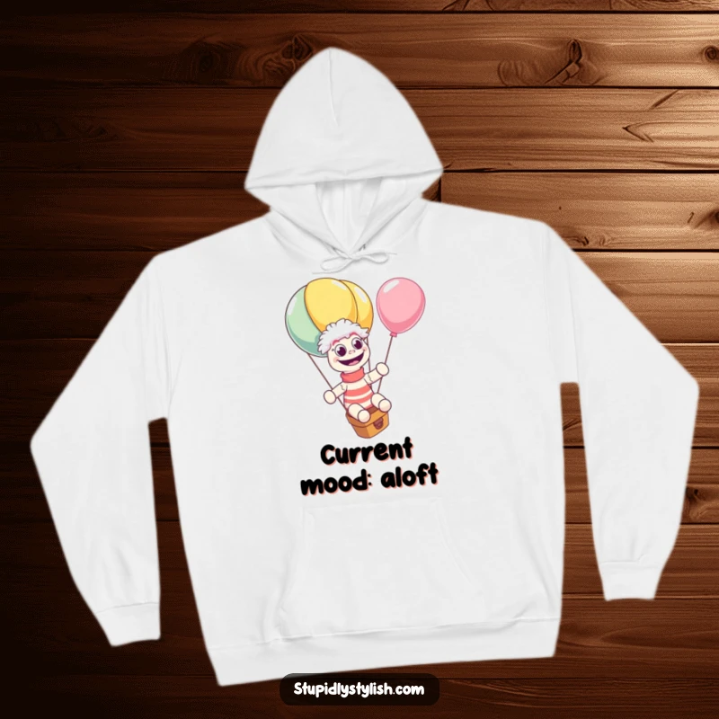 Funny hoodie featuring a delighted sock puppet riding a huge, escaping balloon, wide-eyed with glee. Cozy and comical apparel for chilly days.