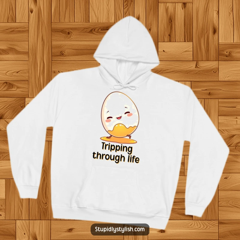 Funny hoodie with a clumsy egg character tripping over its own yolk. Comfortable and humorous apparel.