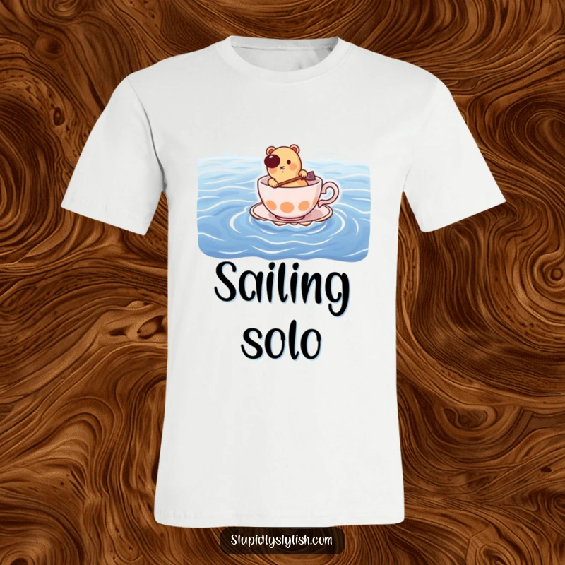 Funny t-shirt: hot dog determinedly paddling a small teacup across a vast ocean, showcasing brave silliness.
