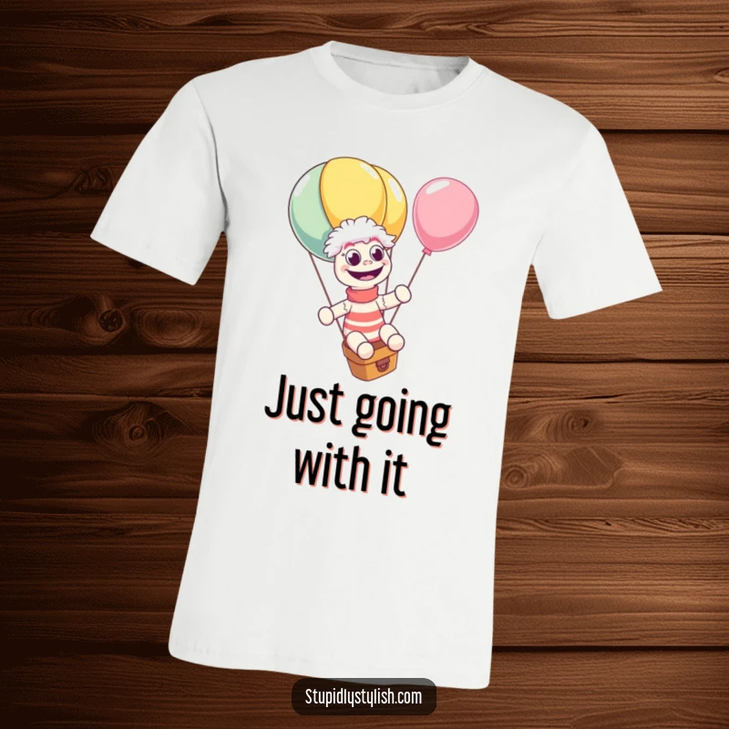 Funny T-shirt print of a giggling sock puppet joyfully riding a massive, runaway balloon with wide, amazed eyes. A whimsical and hilarious apparel choice.